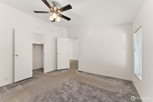 unfurnished bedroom with carpet floors, a ceiling fan, and a closet