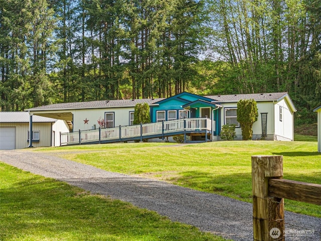 view of front facade featuring driveway, a garage, and an outdoor structure