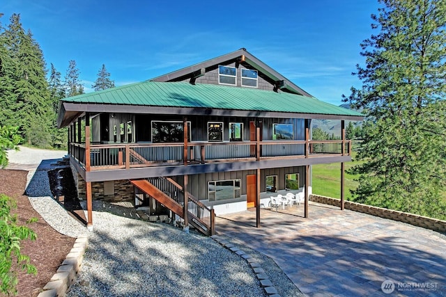 54 Perrow Dr, Winthrop, WA 98862 - view of front of property with a patio, stairs, metal roof, a wooden deck, and board and batten siding