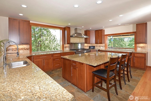 54 Perrow Dr, Winthrop, WA 98862 - kitchen featuring wall chimney exhaust hood, a sink, light stone countertops, tasteful backsplash, and recessed lighting