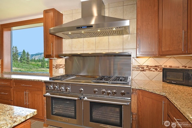 54 Perrow Dr, Winthrop, WA 98862 - kitchen featuring double oven range, wall chimney exhaust hood, black microwave, and brown cabinetry