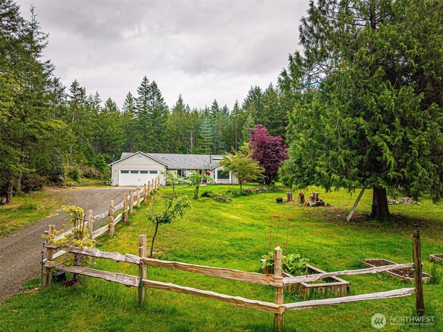 760 Lewis Rd W, Seabeck, WA 98380 - view of front of home featuring driveway, a wooded view, and an attached garage