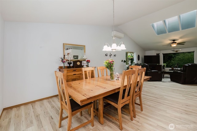 760 Lewis Rd W, Seabeck, WA 98380 - dining space with light wood-style floors, a chandelier, vaulted ceiling, a skylight, and a ceiling fan