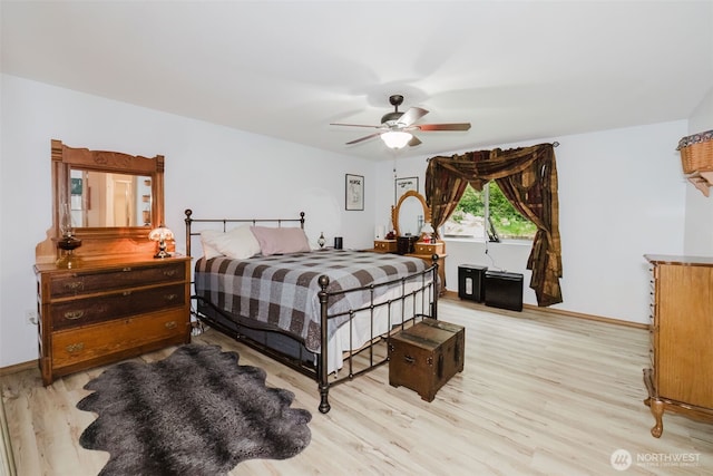 760 Lewis Rd W, Seabeck, WA 98380 - bedroom with light wood finished floors, ceiling fan, and baseboards