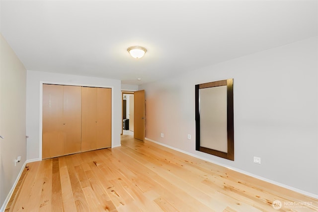 760 Lewis Rd W, Seabeck, WA 98380 - unfurnished bedroom featuring light wood finished floors, baseboards, and a closet