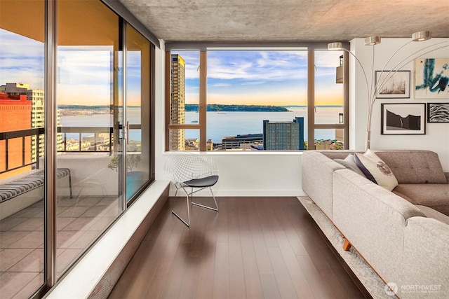 sunroom / solarium featuring a water view