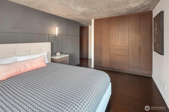 bedroom with dark wood-type flooring
