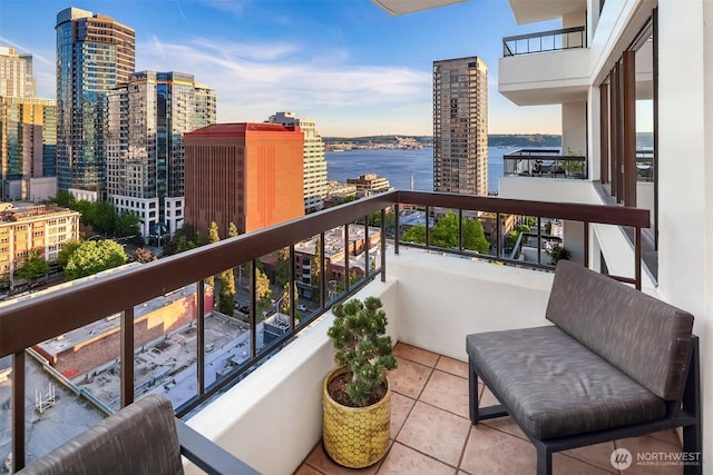 balcony featuring a city view and a water view