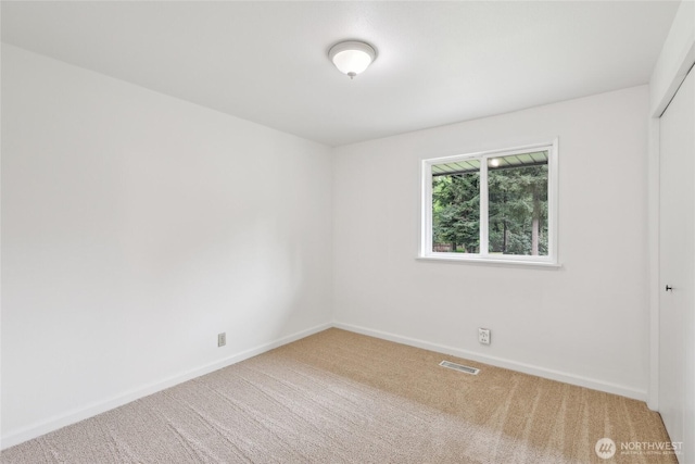 carpeted empty room with baseboards
