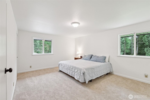 bedroom featuring carpet and baseboards