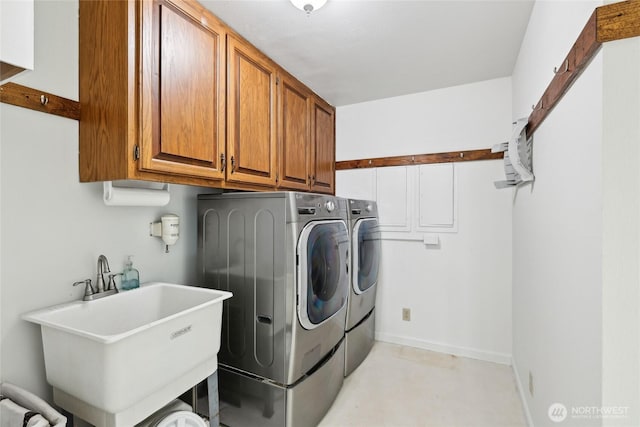 washroom featuring separate washer and dryer and cabinet space