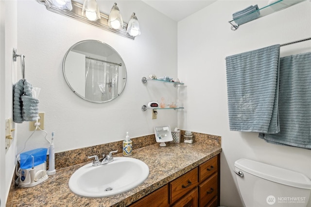 bathroom featuring vanity and toilet