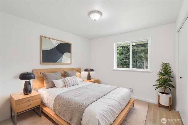 carpeted bedroom featuring baseboards
