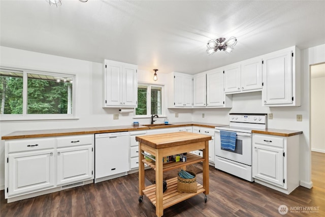 kitchen with white appliances, a sink, white cabinets, and wood counters