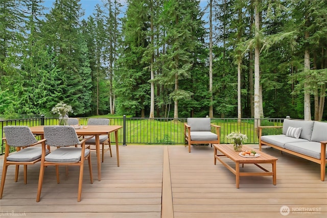 deck with an outdoor hangout area, outdoor dining space, and a yard