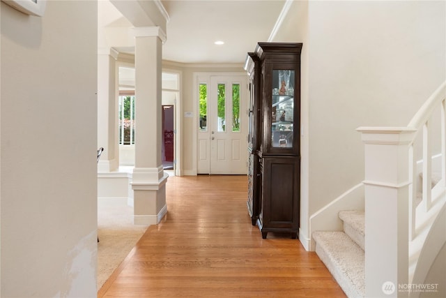 15927 35th Dr SE, Bothell, WA 98012 - entryway featuring ornate columns, light wood-type flooring, stairs, ornamental molding, and recessed lighting
