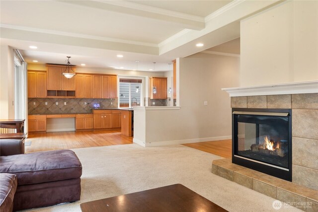 15927 35th Dr SE, Bothell, WA 98012 - living area with crown molding, recessed lighting, a fireplace, light colored carpet, and light wood-style flooring