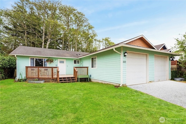 520 E Chance A La Mer NE, Ocean Shores, WA 98569 - view of front of home featuring gravel driveway, a front lawn, a garage, and a wooden deck