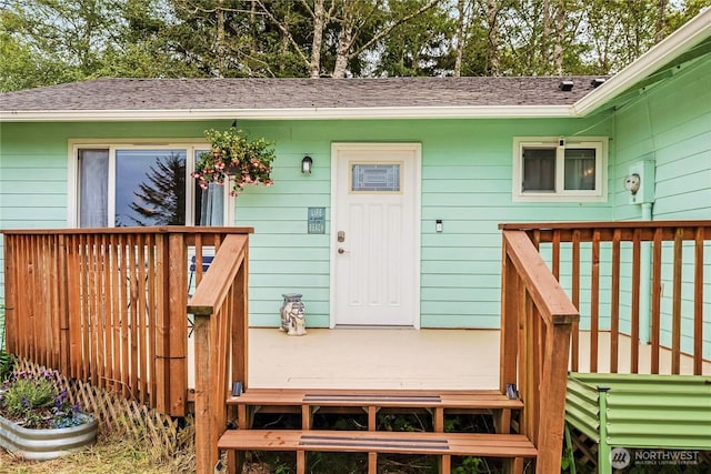520 E Chance A La Mer NE, Ocean Shores, WA 98569 - property entrance featuring a deck and a shingled roof