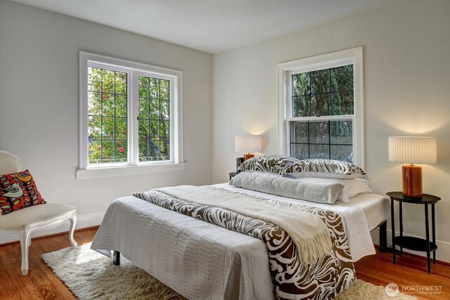 bedroom featuring wood finished floors and baseboards