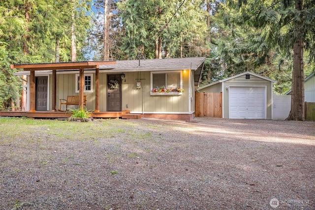 21843 SE Crest Ln SE, Yelm, WA 98597 - view of front facade featuring a detached garage, an outdoor structure, driveway, fence, and board and batten siding