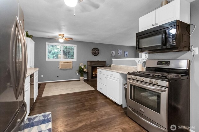 21843 SE Crest Ln SE, Yelm, WA 98597 - kitchen with stainless steel appliances, a ceiling fan, a wall mounted AC, and light countertops