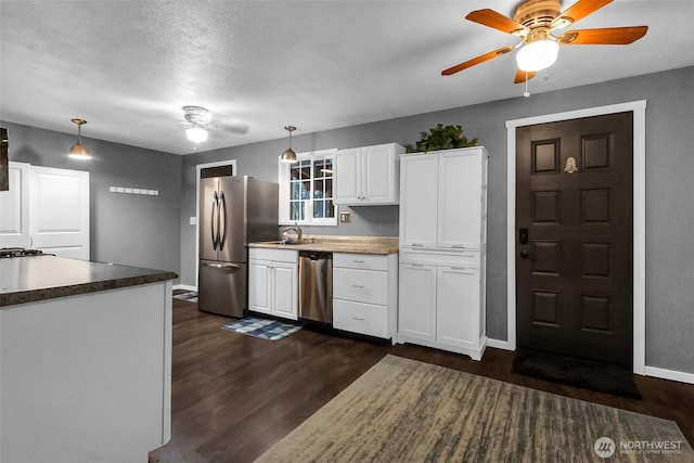 21843 SE Crest Ln SE, Yelm, WA 98597 - kitchen featuring appliances with stainless steel finishes, a ceiling fan, white cabinetry, and dark wood finished floors