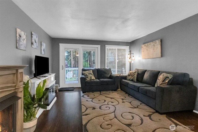 21843 SE Crest Ln SE, Yelm, WA 98597 - living area with wood finished floors and a lit fireplace