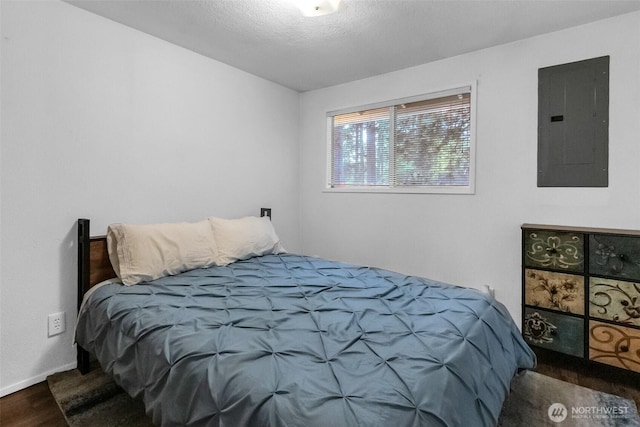 21843 SE Crest Ln SE, Yelm, WA 98597 - bedroom with electric panel, wood finished floors, and baseboards