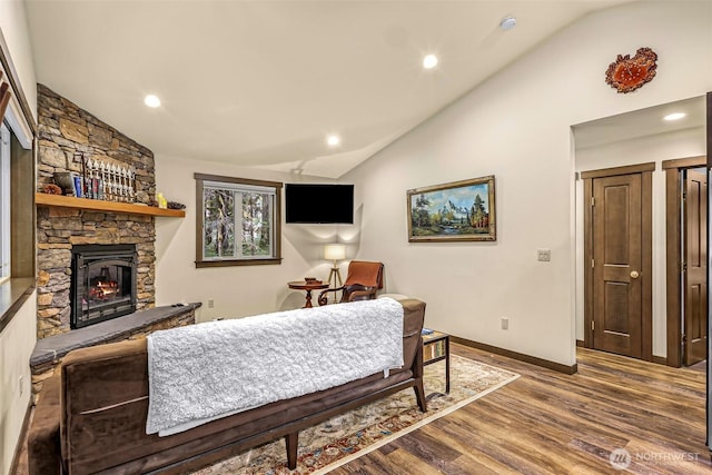 7468 Glacier Springs Dr, Deming, WA 98244 - living room featuring vaulted ceiling, a stone fireplace, wood finished floors, recessed lighting, and baseboards