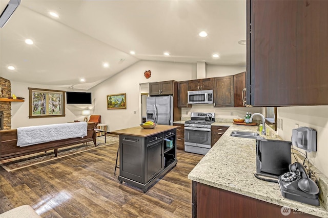 7468 Glacier Springs Dr, Deming, WA 98244 - kitchen featuring stainless steel appliances, a sink, dark wood-type flooring, a kitchen island, and dark brown cabinets