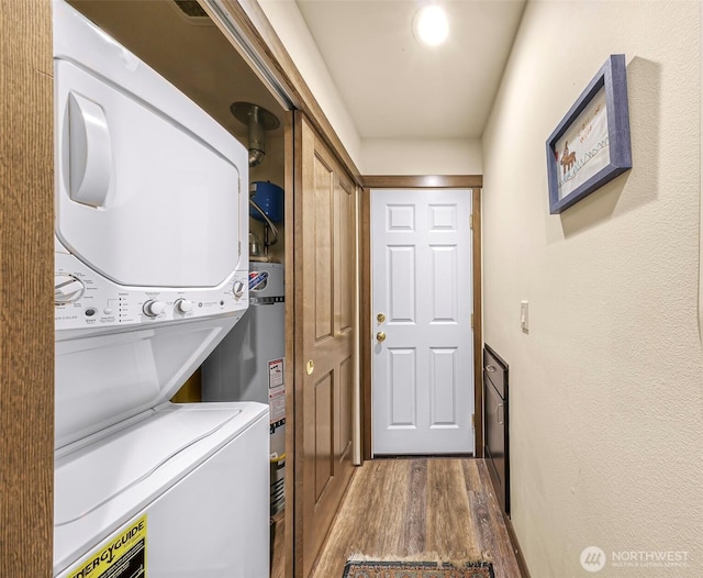 7468 Glacier Springs Dr, Deming, WA 98244 - laundry area with stacked washing machine and dryer, wood finished floors, and secured water heater