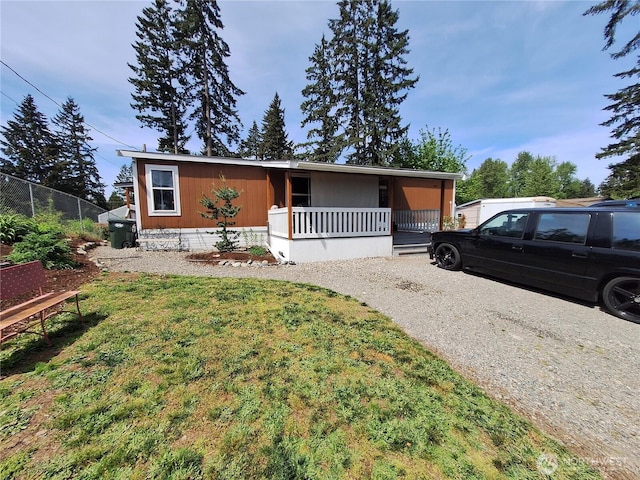 manufactured / mobile home featuring a porch and driveway