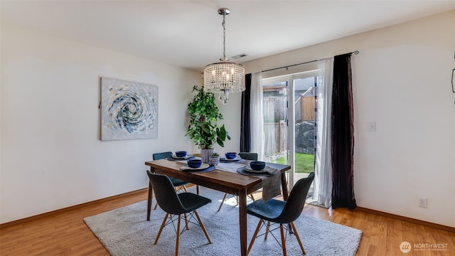 28843 213th Ct SE, Kent, WA 98042 - dining area with a chandelier, light wood-type flooring, and baseboards