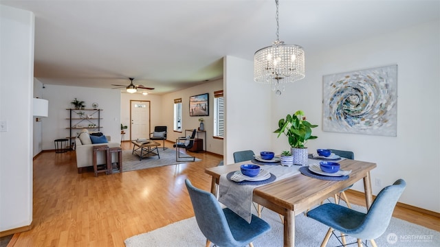 28843 213th Ct SE, Kent, WA 98042 - dining room with light wood-style floors, a chandelier, a ceiling fan, and baseboards