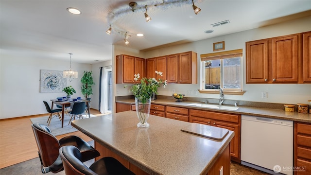 28843 213th Ct SE, Kent, WA 98042 - kitchen featuring dishwasher, a sink, brown cabinetry, and a kitchen bar