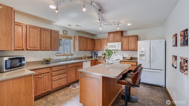 28843 213th Ct SE, Kent, WA 98042 - kitchen with white appliances, a sink, a kitchen breakfast bar, a kitchen island, and light countertops