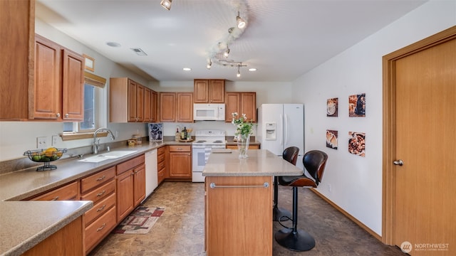 28843 213th Ct SE, Kent, WA 98042 - kitchen with white appliances, a sink, a kitchen breakfast bar, track lighting, and a kitchen island