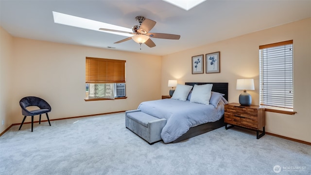 28843 213th Ct SE, Kent, WA 98042 - carpeted bedroom with a skylight, multiple windows, baseboards, and a ceiling fan
