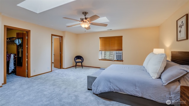 28843 213th Ct SE, Kent, WA 98042 - bedroom with a skylight, a walk in closet, baseboards, ceiling fan, and carpet flooring