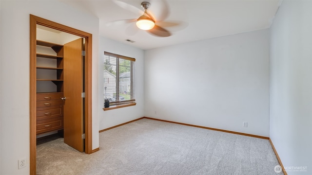 28843 213th Ct SE, Kent, WA 98042 - unfurnished bedroom featuring carpet, a walk in closet, baseboards, and a ceiling fan