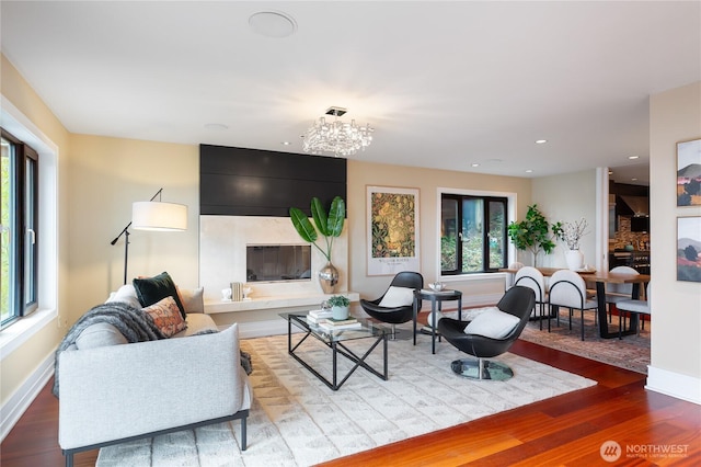 living room with plenty of natural light, baseboards, wood finished floors, and recessed lighting
