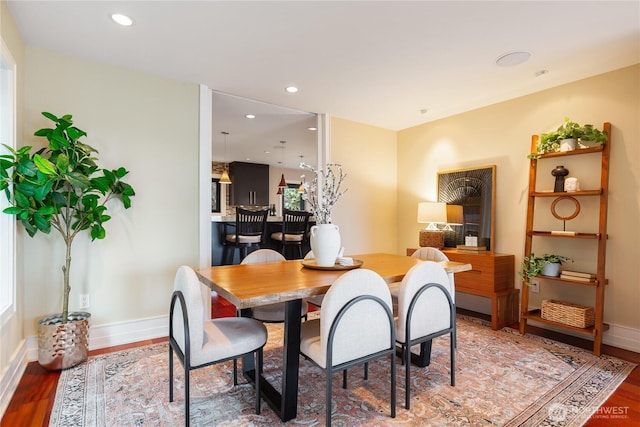 dining space with wood finished floors, baseboards, and recessed lighting