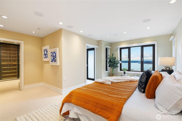 bedroom with recessed lighting, baseboards, light carpet, and a water view
