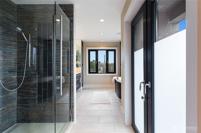 bathroom featuring vanity, a shower stall, tile patterned floors, recessed lighting, and baseboards