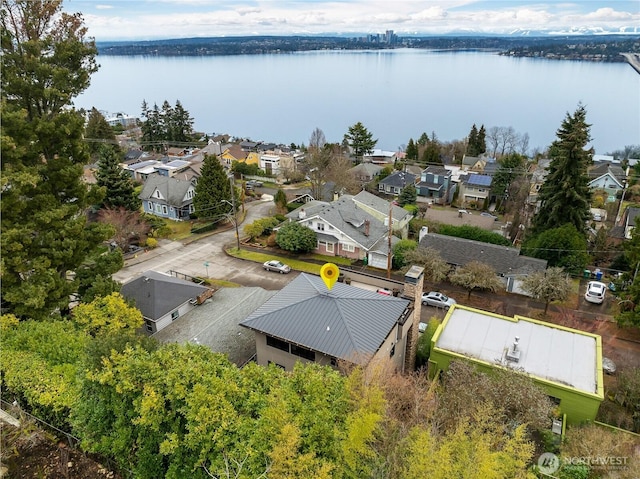 aerial perspective of suburban area featuring a nearby body of water