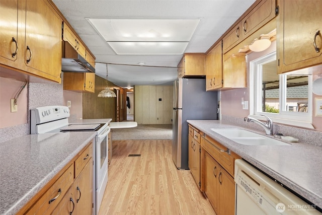 3180 Woodcock Rd, Sequim, WA 98382 - kitchen featuring white appliances, a sink, light wood finished floors, light countertops, and under cabinet range hood