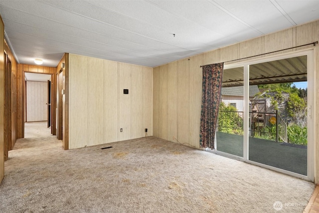 3180 Woodcock Rd, Sequim, WA 98382 - carpeted empty room featuring wood walls