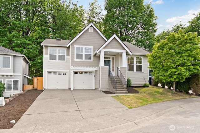 split level home with driveway, an attached garage, and fence