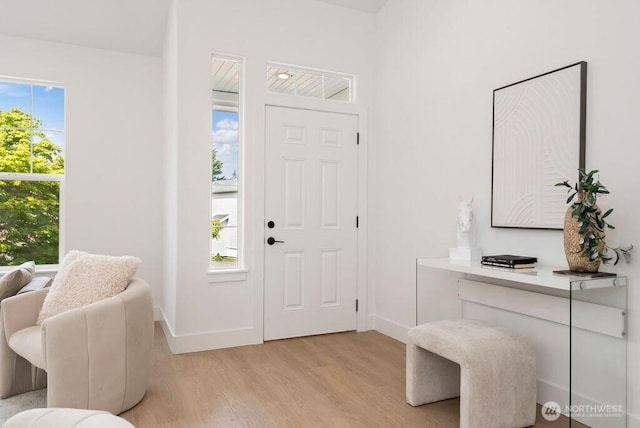 entrance foyer with light wood-style floors and baseboards